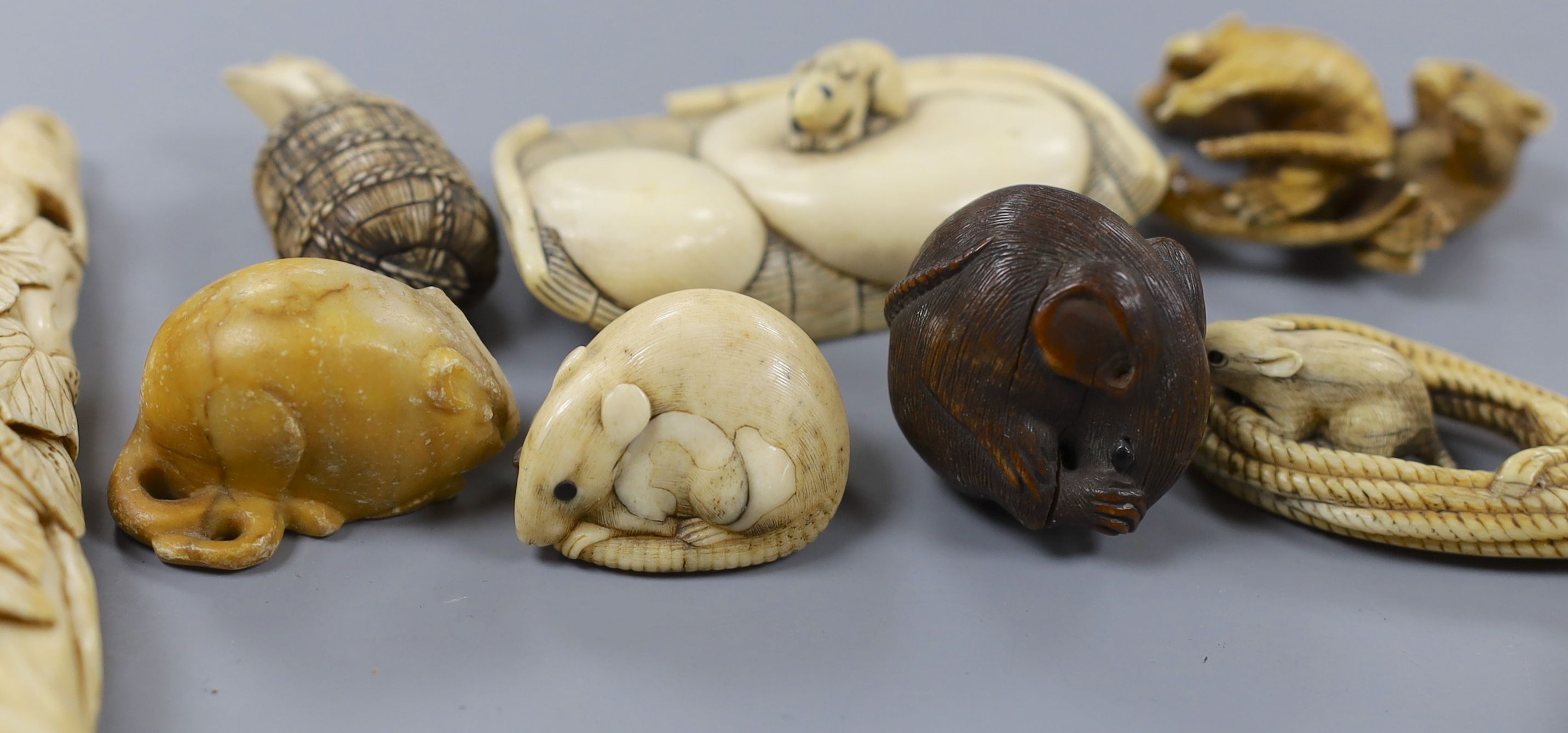 A collection of Japanese ivory and wood netsuke and okimono